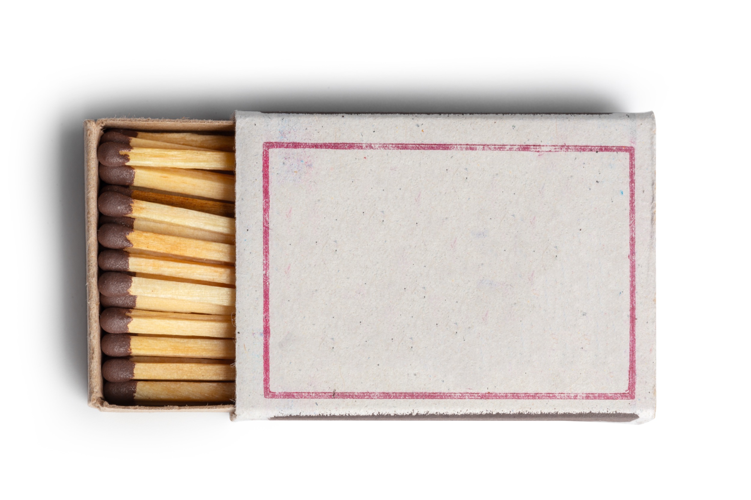 An open matchbox with a blank label and several wooden matches inside, with brown match heads, arranged neatly against a white background.